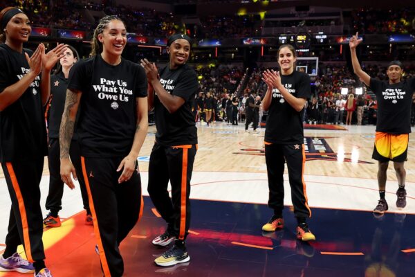 Why WNBA players are wearing ‘pay us what you owe us’ shirts